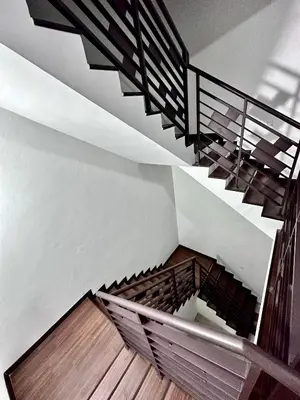 a staircase in a house with a metal railing at Queen’s Villa for 28Pax @Central of Penang in Jelutong