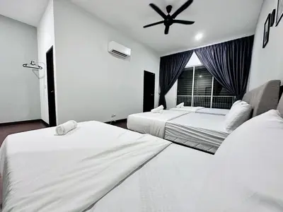 a hotel room with two beds and a ceiling fan at Queen’s Villa for 28Pax @Central of Penang in Jelutong