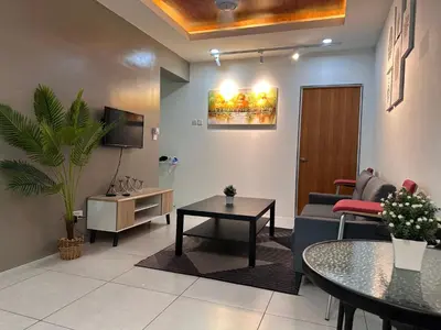a living room with a couch and a table at SZ Home Legacy at Meritus in Perai