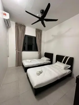 a room with two beds and a ceiling fan at SZ Home Legacy at Meritus in Perai