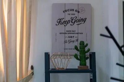 a cactus on a shelf with a sign on a wall at Jemhaus Studio Sunset Seaview [Netflix & Cuckoo] in Lumut