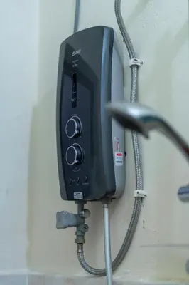 a black phone is hanging on a wall at Jemhaus Studio Sunset Seaview [Netflix & Cuckoo] in Lumut
