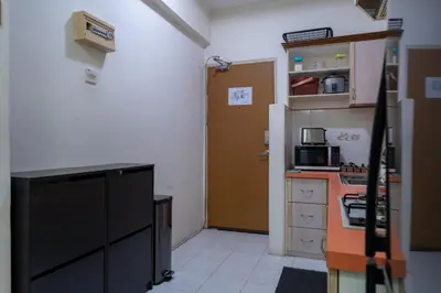 a kitchen with a counter and a door in a room at Jemhaus Studio Sunset Seaview [Netflix & Cuckoo] in Lumut