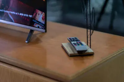 a remote control sitting on top of a table at Jemhaus Studio Sunset Seaview [Netflix & Cuckoo] in Lumut
