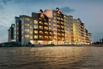 a large building on the beach near the water at D'Sea Marina Island Resort by Manhattan Group in Lumut