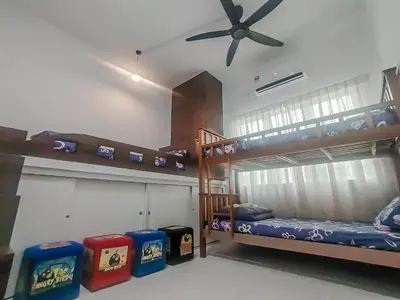 two bunk beds in a room with a ceiling fan at Samudera Seri Manjung Residences by Manhattan Group in Kampong Pundut