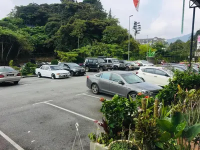a bunch of cars parked in a parking lot at Lily Haven Hotel C-1 in Tanah Rata