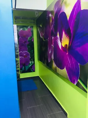 a room with a large purple flower on the wall at Lily Haven Hotel C-1 in Tanah Rata