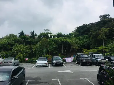 a parking lot with cars parked in it at Lily Haven Hotel C-1 in Tanah Rata