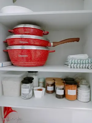a shelf with red bowls and other items in a refrigerator at Homestay Triple Q Manjung in Seri Manjung