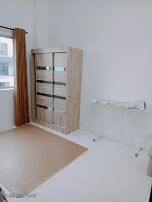a room with a wooden cabinet and a window at Homestay Triple Q Manjung in Seri Manjung