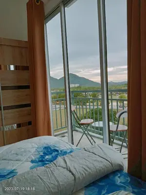 a bedroom with a bed and a balcony with a view at Homestay Triple Q Manjung in Seri Manjung