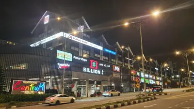 a city street at night with cars parked in front of a building at Emerald New Homstay in Brinchang