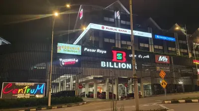 a building with signs on the side of it at night at Emerald New Homstay in Brinchang