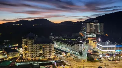 a city lit up at night with buildings at Emerald New Homstay in Brinchang