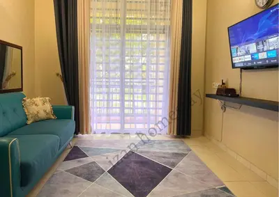 a living room with a couch and a flat screen tv at Anoi Homestay TAMBUN @ Lost World HighSpeed WiFi in Tambun