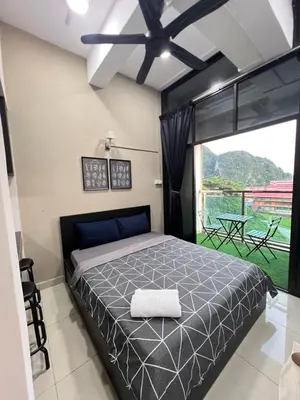 a bedroom with a bed and a large window at GR studio APARTMENT 1 - kompleks MUTIARA gua MUSANG in Gua Musang