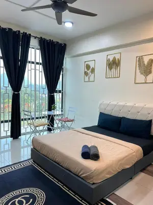 a bedroom with a bed with a ceiling fan at GR studio APARTMENT 1 - kompleks MUTIARA gua MUSANG in Gua Musang