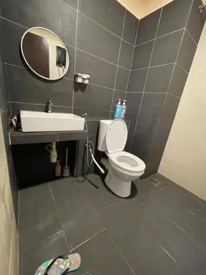 a bathroom with a sink and a toilet and a mirror at GR studio APARTMENT 1 - kompleks MUTIARA gua MUSANG in Gua Musang