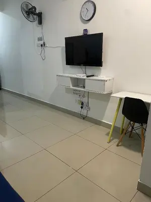 a room with a tv on a wall with a desk at GR studio APARTMENT 1 - kompleks MUTIARA gua MUSANG in Gua Musang
