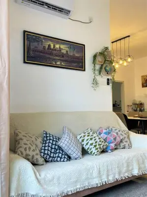 a living room with a couch with pillows on it at The Horizon @ Ipoh - Cozy Condo with Balcony Patio in Ipoh