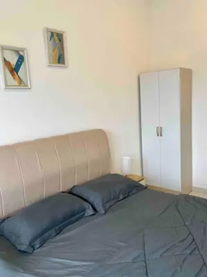 a bed with two blue pillows in a bedroom at The Horizon @ Ipoh - Cozy Condo with Balcony Patio in Ipoh