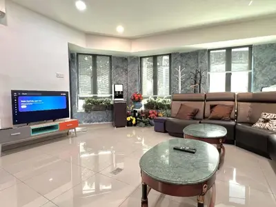 a living room with a couch and a tv at Jovial Boutique Hotel```` Kampung Baru in Bukit Mertajam