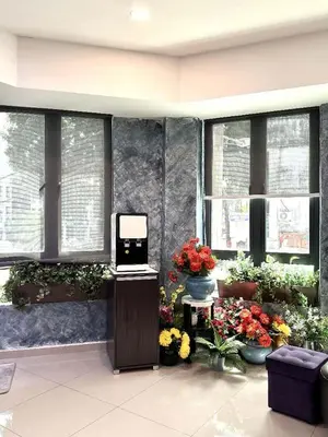a lobby with flowers and plants in a building at Jovial Boutique Hotel```` Kampung Baru in Bukit Mertajam
