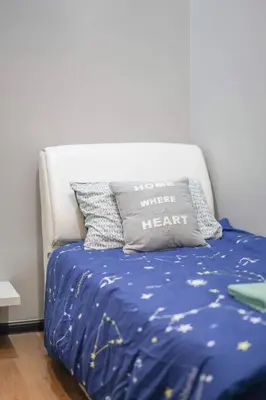 a bed with a blue blanket and a pillow that says you were heart at MODERN HERITAGE HOUSE``````Georgetown\u4e54\u6cbb\u5e02 in George Town