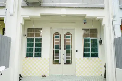 a white front door of a white house at MODERN HERITAGE HOUSE``````Georgetown\u4e54\u6cbb\u5e02 in George Town