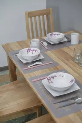 a wooden table with two bowls and plates on it at MODERN HERITAGE HOUSE``````Georgetown\u4e54\u6cbb\u5e02 in George Town