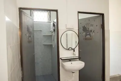 a bathroom with a toilet and a mirror at WY Impian Homestay in Bukit Mertajam