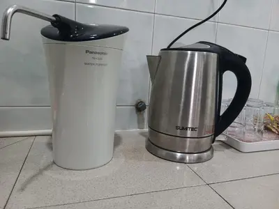 a coffee pot sitting on top of a counter next to a cup at WY Impian Homestay in Bukit Mertajam