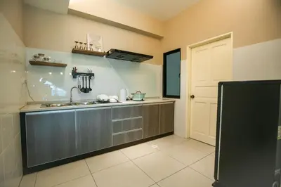 a kitchen with a sink and a counter top at Cosy City-View Suite in Town in Ipoh