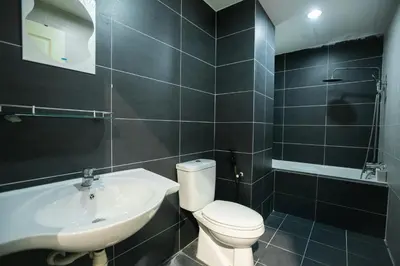 a bathroom with a white toilet and a sink at Cosy City-View Suite in Town in Ipoh
