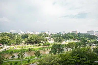a park with trees and a city in the background at Cosy City-View Suite in Town in Ipoh