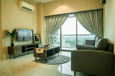 a living room with a couch and a tv at Cosy City-View Suite in Town in Ipoh