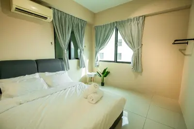 a bedroom with a bed with a towel on it at Cosy City-View Suite in Town in Ipoh