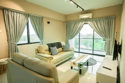 a living room with a couch and a table at Cosy City-View Suite in Town in Ipoh