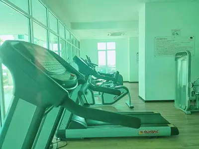 a gym with a row of treadmills at Deluxe Suites 4, 2-5 pax, Netflix, Georgetown in Jelutong