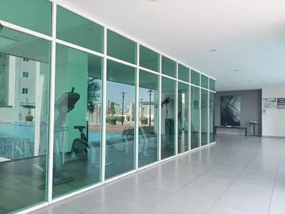 a large glass building with a pool and a gym at Deluxe Suites 4, 2-5 pax, Netflix, Georgetown in Jelutong