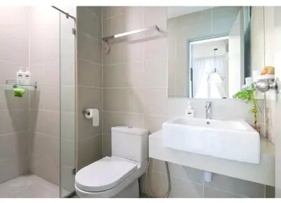 a bathroom with a toilet and a sink and a mirror at Deluxe Suites 4, 2-5 pax, Netflix, Georgetown in Jelutong