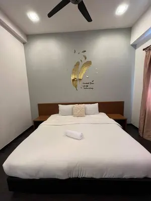 a bedroom with a bed with two butterflies on the wall at Delisha Homestay 3R2B The Retreat,Aranda Nova in Brinchang