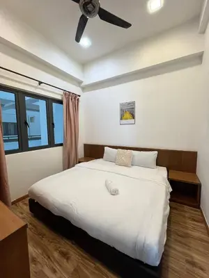 a bedroom with a white bed with a ceiling fan at Delisha Homestay 3R2B The Retreat,Aranda Nova in Brinchang