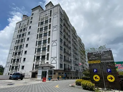 a large white building with a sign in front of it at Delisha Homestay 3R2B The Retreat,Aranda Nova in Brinchang