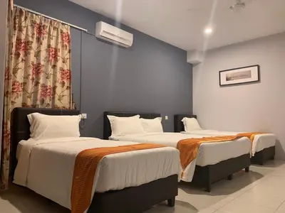 two beds in a hotel room with two bedsvisor at White House Homestay in Ipoh