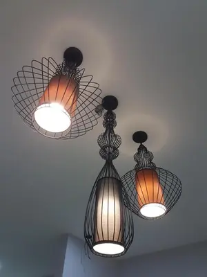 three lights are hanging from the ceiling at White House Homestay in Ipoh