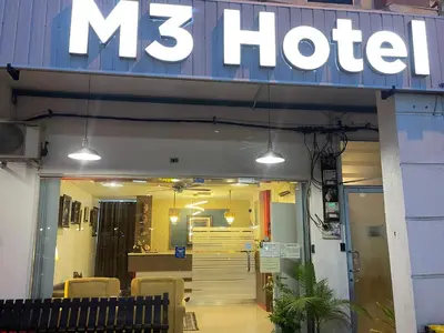 a hotel sign on the front of a building at M Three Hotel in Kampong Batu Tiga