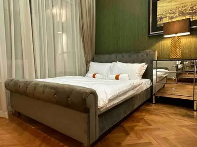 a bedroom with a bed with a green wall at Straits Quay Highest & Spacious Seaview Suite - 2 in Tanjong Tokong