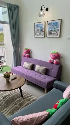 a living room with a purple couch and a table at Sweet Homestay 3RM @ Penthouse Apartment in Brinchang in Brinchang